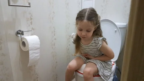 a little girl sitting on the toilet, the... | Stock Video 