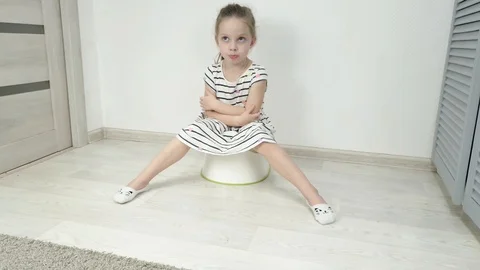 a little girl sitting on the toilet, the... | Stock Video 