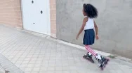 Little Girl Skating By The Street. Afro Girl Outdoor Stock Footage