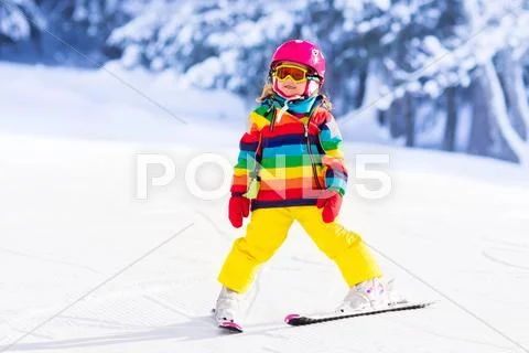 Little girl skiing in the mountains Stock Photos