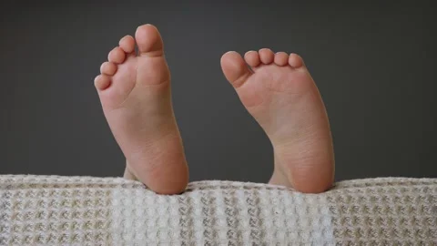 Little girl sleeping in bed. Child feet ... | Stock Video