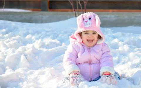 Little girl in snow Stock Photos