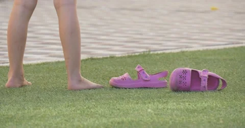 A little girl stands on grass Stock Footage 52364853