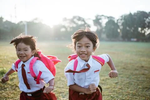 Little girl student running together while going to their school Stock Photos