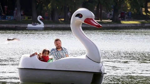 Little Girl in Swan Paddle Boat Fish Feeding Stock Footage