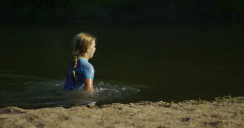 Little Girl Swimming In The Lake - track... | Stock Video | Pond5