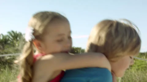 Young girl carrying sister giving piggyback ride Stock Photo