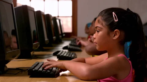Little girl using computer in classroom in school Stock Footage 40407708