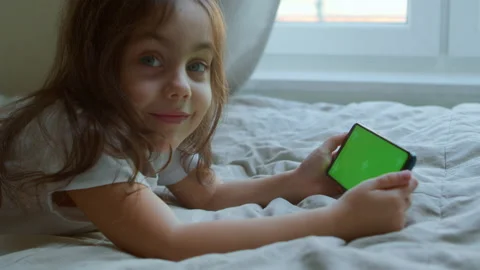 Little girl using green screen smart phone at home. Stock Footage 192513345