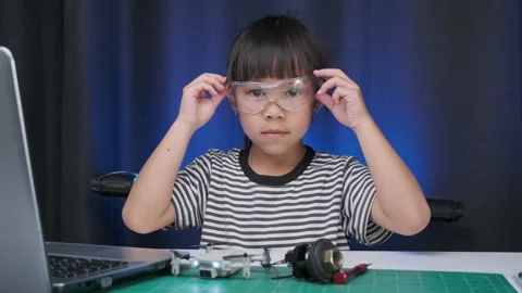 Little girl using laptop to write code and solve engineering problems at home. 스톡 동영상 237498361