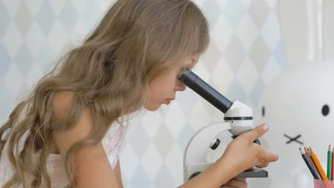 A little girl using a microscope Stock Footage 93933107