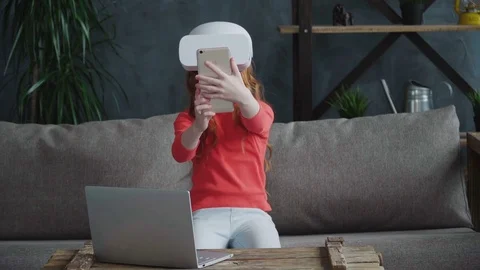 Little girl using virtual reality headset with smartphone in the room Stock Footage 74700894