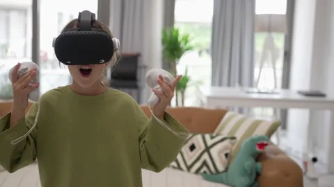 A Little Girl is Using a Virtual Reality Helmet Stock Footage 245485091