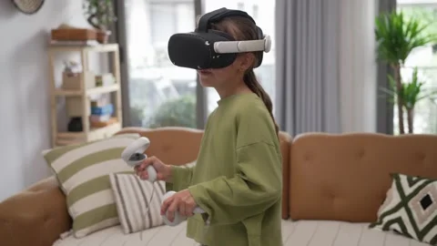 A Little Girl is Using a Virtual Reality Helmet Stock Footage 246738134