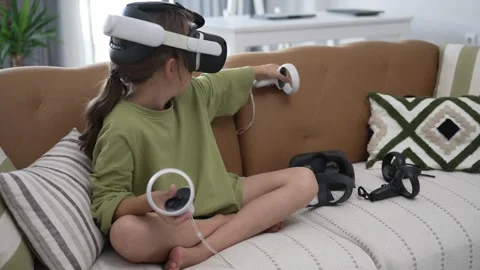 A Little Girl is Using a Virtual Reality Helmet Stock Footage 246738287