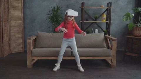 Little girl using VR headset at home Video stock 74542238