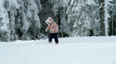 Little girl walking and running on snow Stock Footage