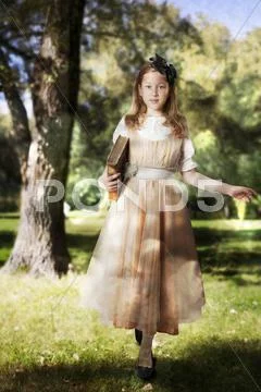 Little girl walking into an enchanted forest Stock Photos