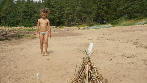 Little girl walks on the beach. Child playing outdoors Stock Footage 95334894