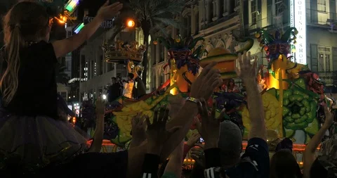 Little girl waves tries to catch beads from Mardi Gras Parade float Orpheus 4K Stock Footage