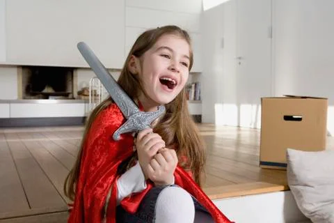 A little girl wearing fancy dress and laughing Stock Photos