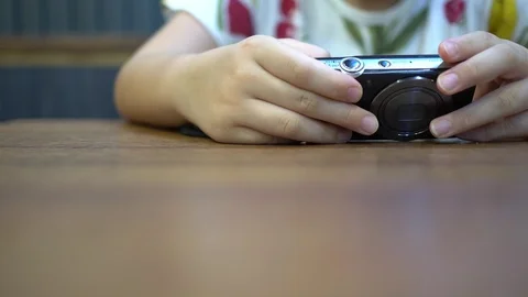 A little girl who is using a digital camera to view photos. Stock Footage 111509853