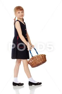 Little girl with a wicker basket Stock Photos