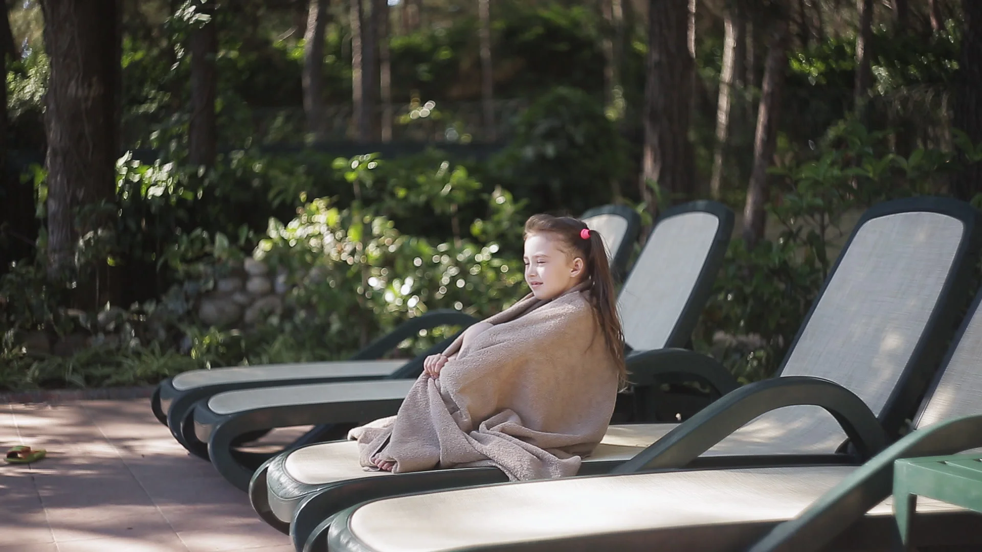 Portrait of young african american woman wrapped in towels sitting