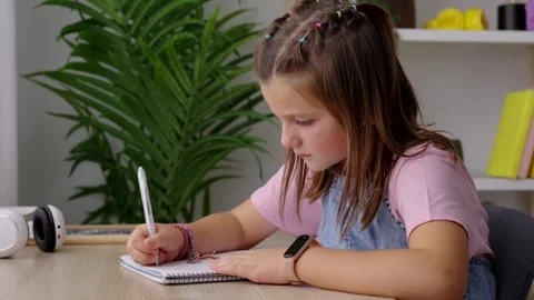 Little girl writing on notebook Stock Footage 252127331