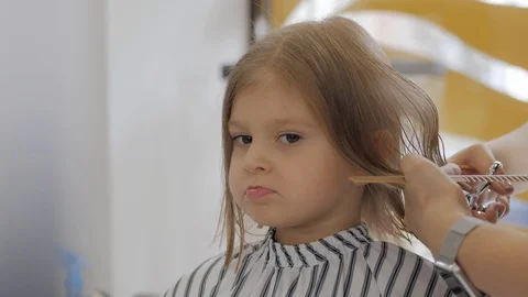 A little girl yawns widely during a hair... | Stock Video | Pond5