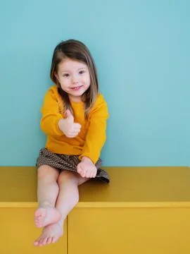 A little girl in a yellow shirt Stock Photos