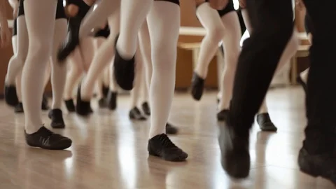 Little girls for a dance class. Close up. Black swimsuit and white tights. Slow Stock Footage 96001644