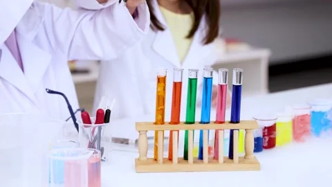 Little Girls Doing Science Experiments With Colorful Test Tubes in Lab Stock Footage 345113908