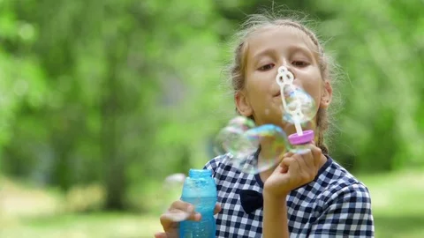 Little girls playing with soap bubbles outdoor. Slow motion. Stock Footage