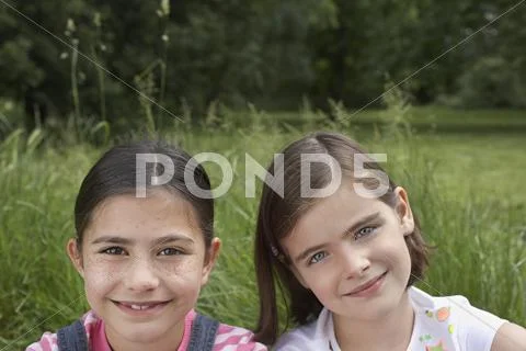 Little Girls Smiling In Field Stock Photos
