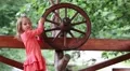 Little girls turn wooden wheel HD Footage