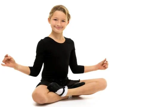 The little gymnast perform an acrobatic element on the floor. Stock Photos
