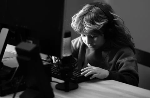 Little hacker, young programmer. Child with pc computer at night. Overuse and Stock Photos