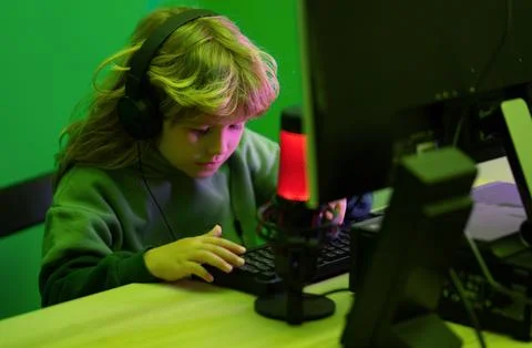 Little hacker, young programmer. Child with pc computer at night. Overuse and Stock Photos