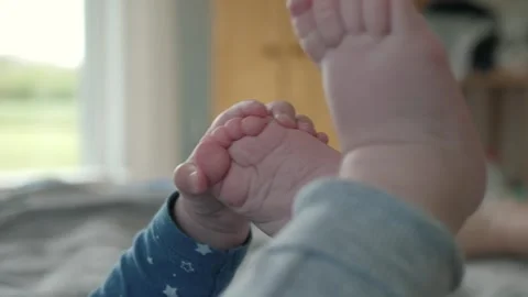 Little hand playing with feet Stock Footage 301008314