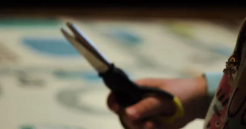 Little hands cut paper with scissors. learning how use sharp scissors Stock Footage 274880489