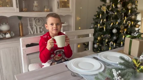 Little happy boy is drinking hot chocolate. Stock Footage 221001107