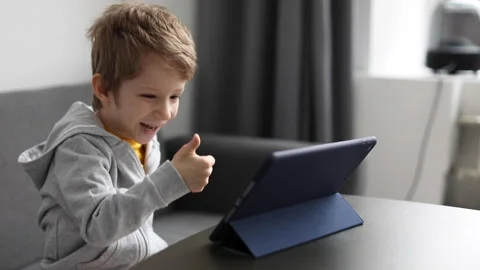 Little happy boy smiling while playing with digital tablet at home. Free time Stock Footage 168906711