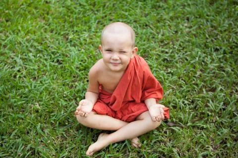 Little happy smiley monk meditating Stock Photos