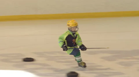 Little hockey player does an exercise on an ice Stock Footage 68687547