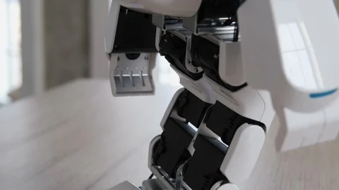 Little humanoid robot takes steps back and forth Stock Footage 106351754