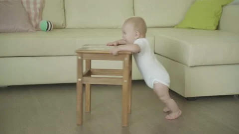 Little Infant Learns To Walk Using A Stool Talking Ahead Video stock 137729342