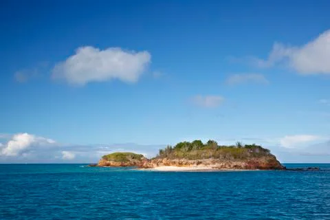 A little island with a tiny beach close to the coastline of Antigua in the Ca Stock Photos