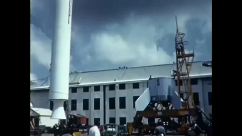 A Little Joe II rocket section is lifted and lowered into a larger section at an Stock Footage 93508472