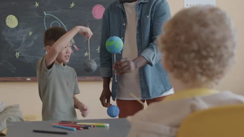 Little Kid Answering Teachers Question on Astronomy Lesson Stock Footage 255434403